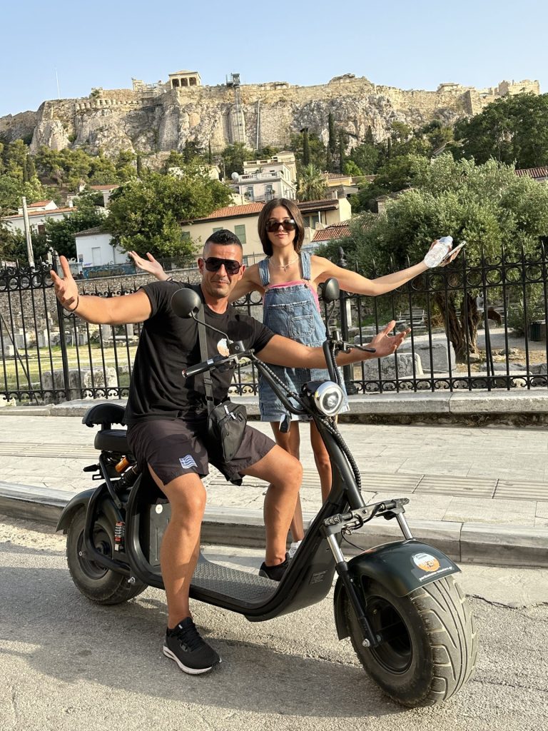 my friend was taking pictures of me below the Acropolis, and this guy riding his moped stopped to join in on the photo